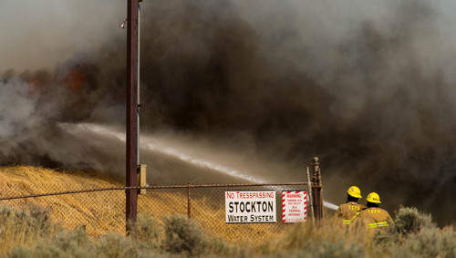 Trent Nelson  |  The Salt Lake Tribune
Firefighters work to extinguish a fire in Stockton, Wednesday July 16, 2014.