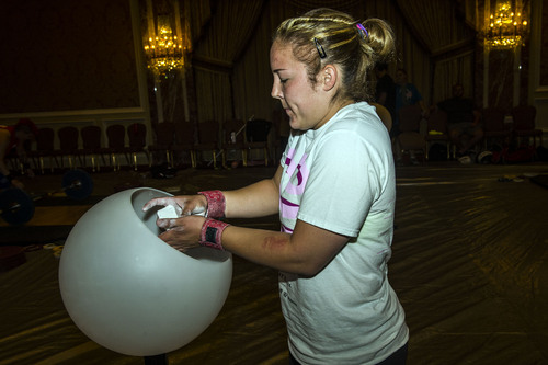 Chris Detrick  |  The Salt Lake Tribune
Maegan Snodgrass, of Salt Lake City, puts chalk on her hands before practiceing the snatch before competing in the USA Weightlifting National Championships at The Grand America Hotel Thursday July 17, 2014.