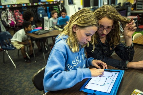 Chris Detrick  |  The Salt Lake Tribune
Kynslie Ballamis, left, and Jade Torbeck use an iPad to help learn about American history at Bennion Elementary School in May. With new academic standards continuing to divide some educators, lawmakers and parents, Gov. Gary Herbert is asking the Utah Attorney General's Office to reexamine the state's adoption of them.