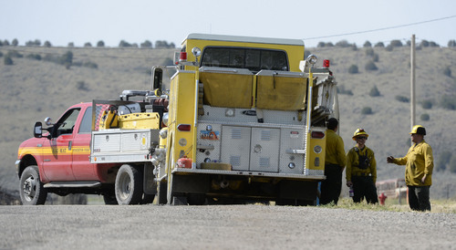 Al Hartmann  |  The Salt Lake Tribune 
Wild land fire fighters from several fire agencies finished mopping up the hot spots of the 179 acre fire.  The town's water tank was burned in the fire necessitating a no use water rule for part of town.