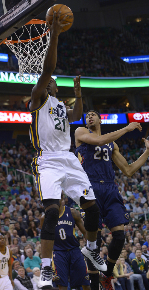 Leah Hogsten  |  The Salt Lake Tribune
Utah Jazz guard Ian Clark (21) drives to the net over New Orleans Pelicans forward Anthony Davis (23). The Utah Jazz defeated the New Orleans Pelicans 100-96 during their game Friday, April 4, 2014 at Energy Solutions Arena.