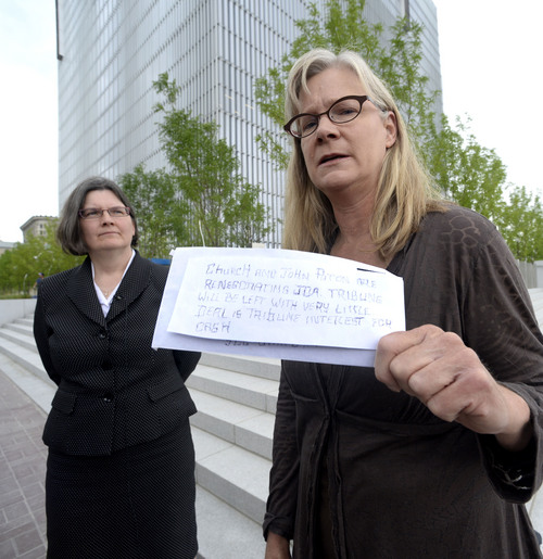 Al Hartmann  |  The Salt Lake Tribune
Former Tribune staffer Joan O'Brien, right,  with lawyer Karra Porter pause on the steps of the Federal Courthouse in Salt Lake City Monday June 16 after filing an injunction in U.S District Court seeking an injunction blocking the paper's new profit-sharing split and other key provisions of the partnership with the Deseret News.   She holds an anonymous letter sent to reporters at the Tribune before the change of the profit sharing split was changed.