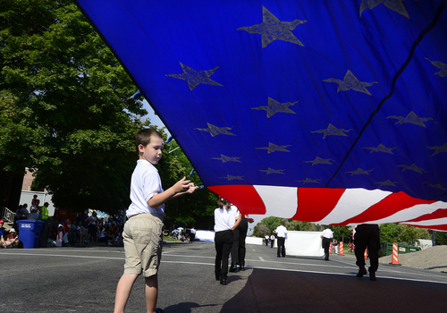 Scott Sommerdorf   |  The Salt Lake Tribune
The Lake Ridge Honor Guard's Ben Simper, 5, helps hold a huge American flag during the annual Days of '47 Youth Parade as it flowed through downtown Salt Lake City, going west on 500 South and ending at Washington Square, where the Days of '47 Family Festival was held, Saturday, July 19, 2014.
