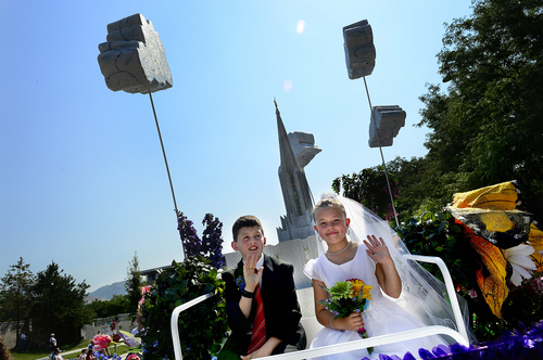 Scott Sommerdorf   |  The Salt Lake Tribune
A young boy and girl pose as a married couple on the West Jordan Primary float during the annual Days of '47 Youth Parade as it flowed through downtown Salt Lake City, going west on 500 South and ending at Washington Square, where the Days of '47 Family Festival was held, Saturday, July 19, 2014.