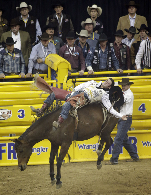 Kaycee Feild competes in the bareback riding event during the tenth go-round of the National Finals Rodeo on Saturday, Dec. 14, 2013, in Las Vegas. (AP Photo/Isaac Brekken)