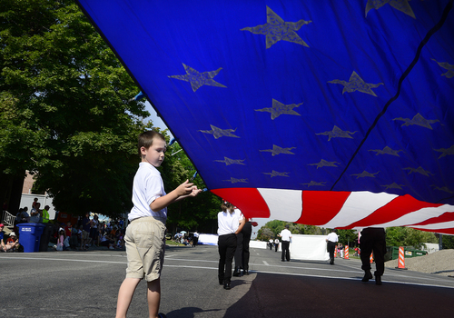 Scott Sommerdorf   |  The Salt Lake Tribune
The Lake Ridge Honor Guard's Ben Simper, 5, helps hold the flag during the annual Days of '47 Youth Parade as it flowed through downtown Salt Lake City, going west on 500 South and ending at Washington Square, where the Days of '47 Family Festival was held, Saturday, July 19, 2014.