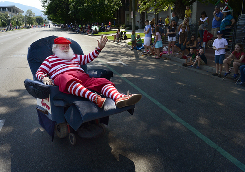 Scott Sommerdorf   |  The Salt Lake Tribune
"Santa In Summer" parades on his motorized easy chair during the annual Days of '47 Youth Parade as it flowed through downtown Salt Lake City, going west on 500 South and ending at Washington Square, where the Days of '47 Family Festival was held, Saturday, July 19, 2014.