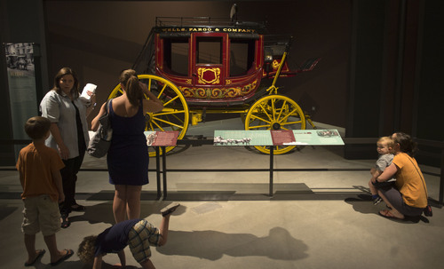 Steve Griffin  |  The Salt Lake Tribune


Visitors look at a Wells Fargo and Company stage coach during the opening of "The Horse"--an exhibit from the American Museum of Natural History in New York City, in Salt Lake City, Utah Monday, July 21, 2014.  The exhibit illuminates the story of how humans have shaped the horse and how the horse, in turn, has shaped us. The special exhibition includes cultural objects from around the world, a hand-painted diorama depicting the evolution of the horse and interactive displays that invite visitors to test their strength in horsepower, identify different breeds and look inside a life-size, moving horse.