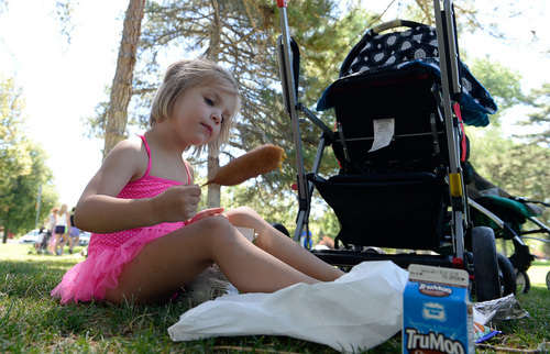 Francisco Kjolseth  |  The Salt Lake Tribune
Chloe Cannon, 4, gives mustard a try as kids gather for the school lunch program at Liberty Park on Monday, July 21, 2014, where they average around 200 kids a day from June 9 to Aug. 19.