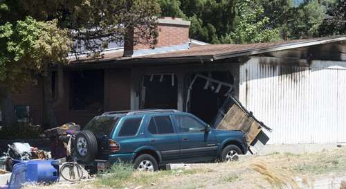 Steve Griffin  |  The Salt Lake Tribune


The garage of this house near 7400 south 2200 east in Cottonwood Heights, Utah is burned out following a fire at the residence Tuesday, July 22, 2014.