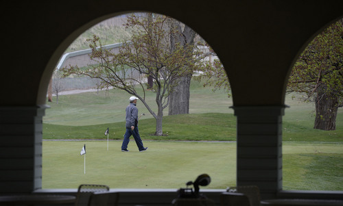 Al Hartmann  |  The Salt Lake Tribune
Golfer warms up on chipping green at Forestdale Golf course in Salt Lake City Monday April 1 waiting for the hail storm to pass.