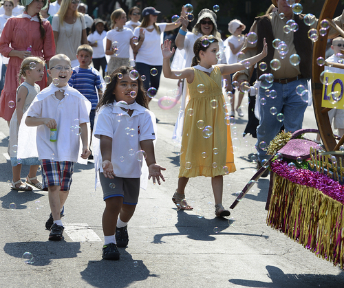 Scott Sommerdorf   |  The Salt Lake Tribune
Children chase soap bubbles during the annual Days of '47 Youth Parade as it flowed through downtown Salt Lake City going west on 500 South and ending at Washington Square, where the Days of '47 Family Festival was held, Saturday, July 19, 2014.