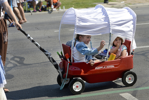 Scott Sommerdorf   |  The Salt Lake Tribune
Girls in a makeshift covered wagon are pulled during the annual Days of '47 Youth Parade as it flowed through downtown Salt Lake City going west on 500 South and ending at Washington Square, where the Days of '47 Family Festival was held on Saturday.