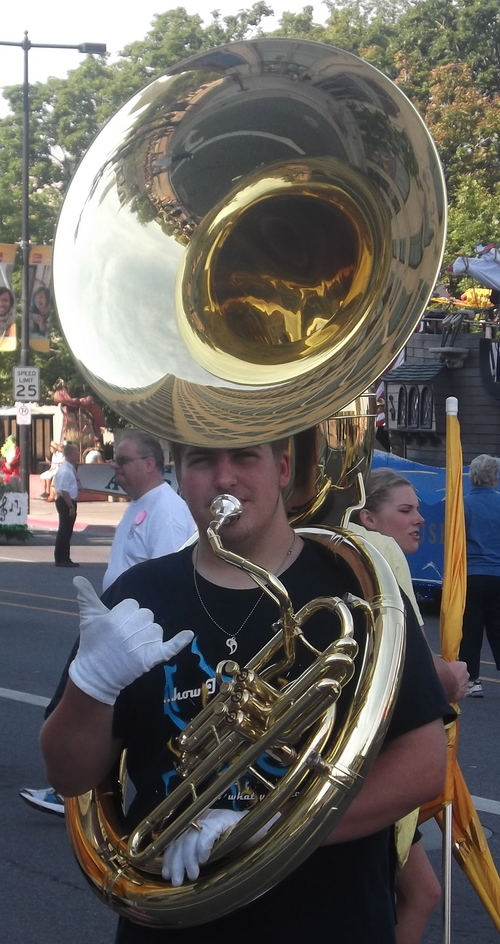 Sean P. Means  |  The Salt Lake Tribune
Jackson Smith, 17, sousaphone section leader for the Davis High School marching band, flashes a sign while waiting for the start of the 2014 Days of '47 Parade in downtown Salt Lake City, Thursday, July 24, 2014.