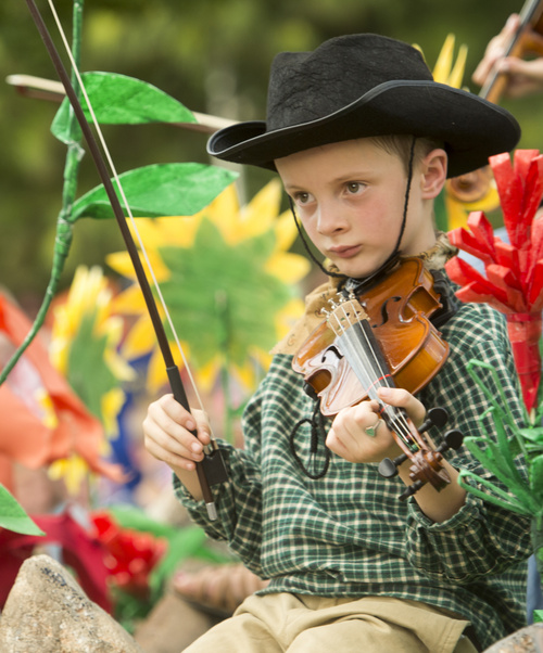Rick Egan  |  The Salt Lake Tribune
Brett Sorenson, 7, plays the fiddle with the North Canyon Stake float in the Handcart Days Parade in Bountiful on Wednesday.