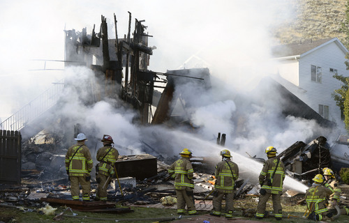 Al Hartmann  |  The Salt Lake Tribune 
Unified Fire and emergency personnel respond to an explosion and fire at 15091 South Junction Circle in Draper on Friday.