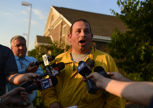 Scott Sommerdorf   |  The Salt Lake Tribune
Tyler Rowser, a spokesman for the North Summit Fire Department, speaks to the media on Friday evening to report that the fire had been deemed 45 percent contained.