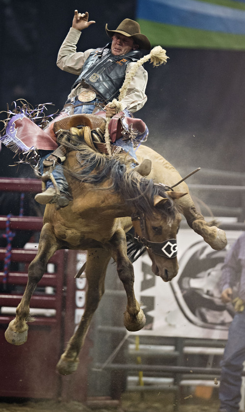 Lennie Mahler  |  The Salt Lake Tribune
Cody Wright of Milford, Utah, scores an 88 in saddle bronc riding at the Days of '47 Rodeo at EnergySolutions Arena, Friday, July 25, 2014.