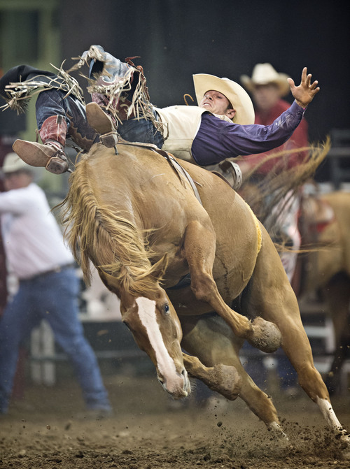 Lennie Mahler  |  The Salt Lake Tribune
Mason Clements scores a 66 in the bareback bronc riding event of the Days of '47 Rodeo at EnergySolutions Arena, Friday, July 25, 2014.