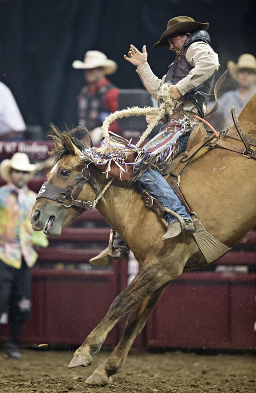 Lennie Mahler  |  The Salt Lake Tribune
Cody Wright of Milford, Utah, scores an 88 in saddle bronc riding at the Days of '47 Rodeo at EnergySolutions Arena, Friday, July 25, 2014.
