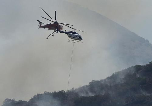 Scott Sommerdorf | The Salt Lake Tribune

Two helicopters help fight a fire east of Springville on July 26, 2014.