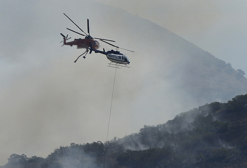 Scott Sommerdorf   |  The Salt Lake Tribune
Two firefighting helicopters extremely close to each other while fighting a brush fire in the hills east of Springville, Saturday, July 26, 2014.