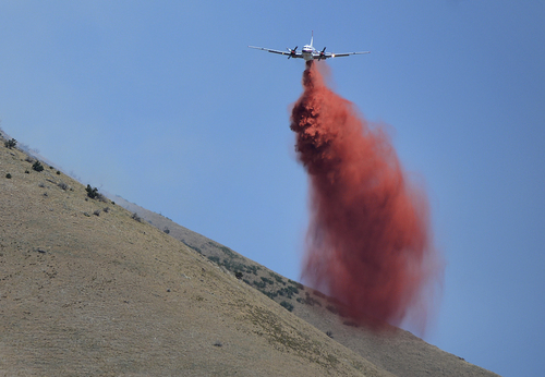 Scott Sommerdorf   |  The Salt Lake Tribune
A heavy air tanker drops it's cargo of fire retardant in the hills east of Springville, Saturday, July 26, 2014.