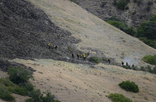Scott Sommerdorf   |  The Salt Lake Tribune
Fire crews on foot work to clean up hotspots in the hills east of Springville, Saturday, July 26, 2014.
