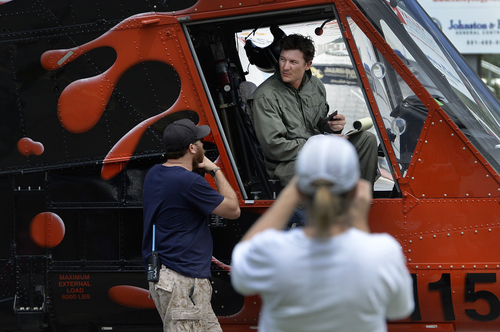 Scott Sommerdorf   |  The Salt Lake Tribune
Helicopter pilot Tyler Burrows, from Bozeman, Montana talks with ground crew as his copter is refueled at Springville High School after fighting the fire in the hills east of Springville on Saturday.