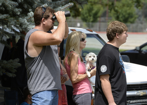 Scott Sommerdorf   |  The Salt Lake Tribune
Mike Pool, left, and his mother in-law Judy GAvin with her dog "Bentley" watch  the firefighting aircraft attack hotspots in the hills east of Springville, Saturday, July 26, 2014.