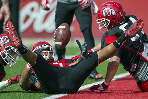 Chris Detrick  |  The Salt Lake Tribune
Utah Utes running back Devontae Booker (27) looses control of the ball while being stopped at the goal line by Utah Utes Tanner Larsen during a scrimmage at Rice-Eccles Stadium DOW} April 12, 2014.
