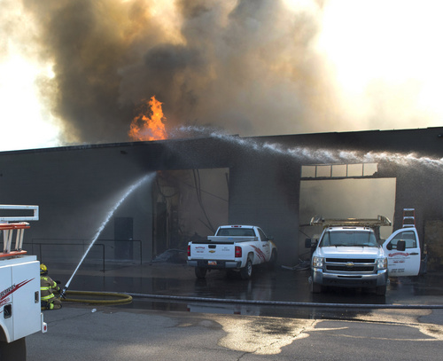 Rick Egan  |  The Salt Lake Tribune

Firefighters spray hot spots on a business at 2481 South 1060 West in Woods Cross, Friday, July 25, 2014
