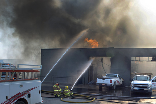 Rick Egan  |  The Salt Lake Tribune
Firefighters spray hot spots on a business at 2481 South 1060 West in Woods Cross on Friday.
