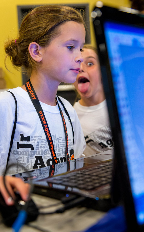 Trent Nelson  |  The Salt Lake Tribune
Sadie Badger gets photobombed while working in a 3-D printing class put on by Geek Squad Academy at the Discovery Gateway Children's Museum in Salt Lake City, Wednesday July 16, 2014.  The two-day camp puts kids through five different classes: 3-D imaging, film and script, digital music, digital responsibility and robotics.
