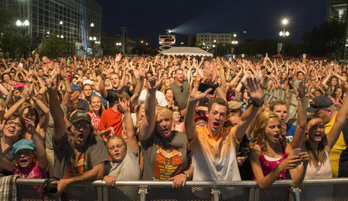 Rick Egan  |  The Salt Lake Tribune

Train fans cheer as the band plays a free concert outside EnergySolutions Arena, Saturday, July 26, 2014