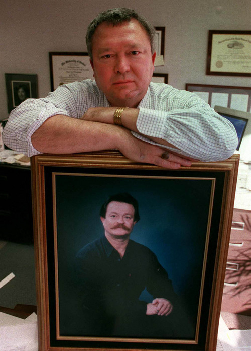 Jesse Trentadue, a Salt Lake City attorney, is shown in his office with a picture of his brother, Kenneth. Kenneth Trentadue was found hanging from a noose made of torn bed sheets in a federal prison cell on Aug. 21, 1995. The death was ruled a suicide, but Jesse Trentadue believes his brother was killed after being mistaken for an Oklahoma City bombing conspirator. 
  Tim Kelly