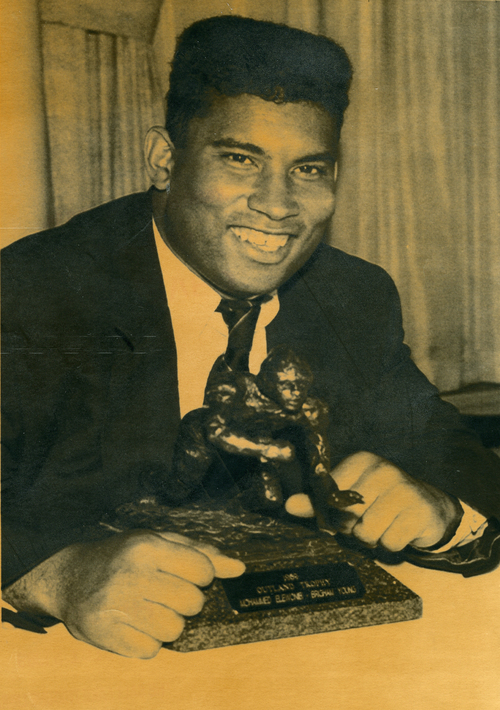 NEW YORK - Mohammad "Moe" Elewonibi of Brigham Young University poses with the Outland Trophy at award ceremonies in New York Wednesday afternoon.  Elewonibi, a 290-pound guard who is the son of a Canadian father and Nigerian mother, received the trophy as outstanding college football lineman.  AP/December 6, 1989.  Tribune file photo received December 15, 1989.