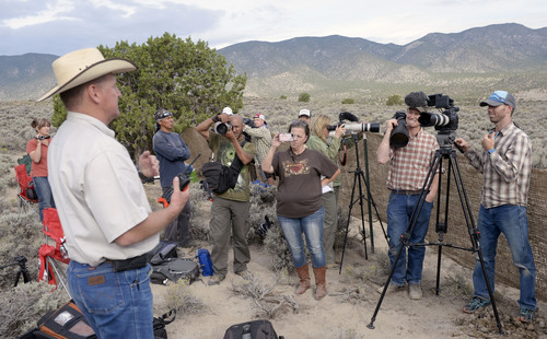 Al Hartmann  |  The Salt Lake Tribune 
Gus Warr, head of the BLM wild horse and burro program for Utah talks with wild horse preservation members , documentary photographers and members of the public 35 miles southwest of Milford Monday July 28 during a helicopter roundup of wild horses in Blawn Wash, a  remote area of basin and range that straddles Beaver and Iron counties.   Warr looked at it as an educational opportunity for local ranchers and members of wild horse organizations to listen and learn from each other.
