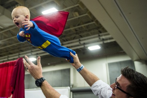 Chris Detrick  |  The Salt Lake Tribune
Super Man Deacon Ely, 10 months, flies through the air with the help of his dad Tyler at Salt Lake Comic Con FanXperience at the Salt Palace Convention Center on Saturday.