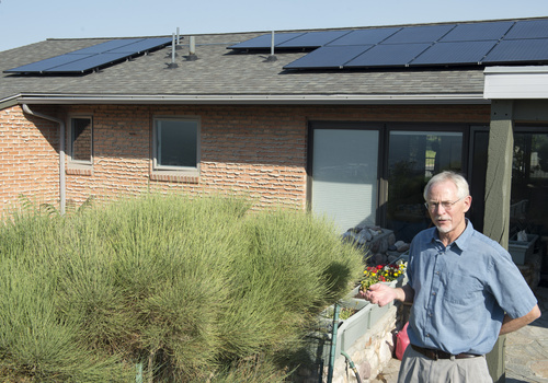 Rick Egan  |  The Salt Lake Tribune

Stan Holmes talks about the solar panels he installed on his roof, Rocky Mountain power wants net-metered customers like Holmes, who have invested thousands in solar arrays to pay a monthly fee, Friday, July 25, 2014