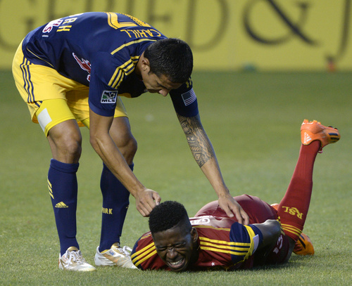 Rick Egan  |  The Salt Lake Tribune

Real Salt Lake forward Olmes Garcia (13) grimaces as New York Red Bulls midfielder Tim Cahill (17) checks to see how he's dpong, in MLS action at Rio Tinto Stadium, Wednesday, July 30, 2014