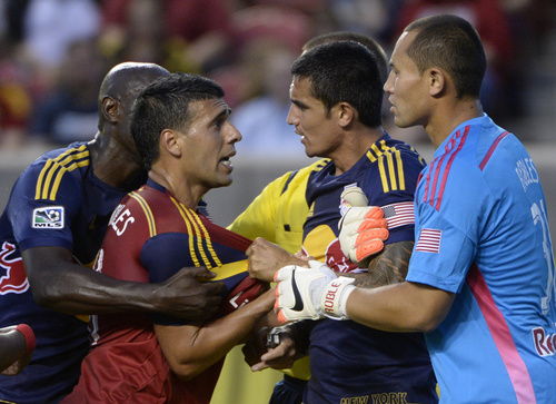 Real Salt Lake midfielder Javier Morales (11) gets mixed up with New York Red Bulls midfielder Tim Cahill (17) and New York Red Bulls goalkeeper Luis Robles (31), in MLS action at Rio Tinto Stadium, in Salt Lake City, Wednesday, July 30, 2014. (AP Photo/The Salt Lake Tribune, Rick Egan)