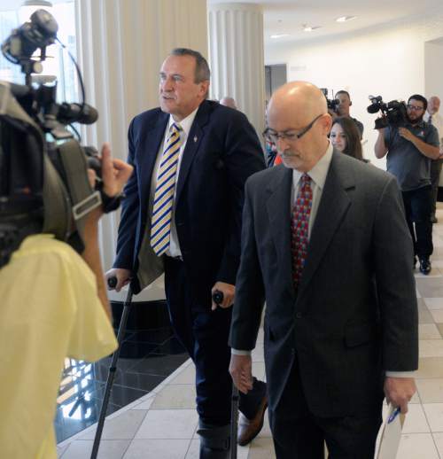 Al Hartmann  |  The Salt Lake Tribune 
Former attorney general Mark Shurtleff, left, walks with his attorney Rick Van Waggoner surrounded by media after his first court appearances in Judge Royal Hansen's courthroom in Salt Lake City Wednesday July 30 on charges of receiving or soliciting bribes, accepting gifts, tampering with evidence, obstructing justice and participating in a pattern of unlawful conduct.