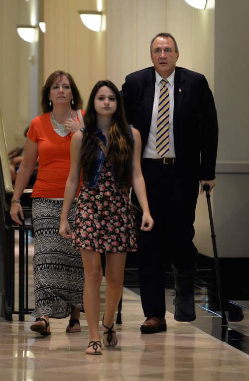 Scott Sommerdorf   |  The Salt Lake Tribune
Former Utah attorney general Mark Shurtleff, arrives with his wife M'Liss and his daughter Danielle to make his initial court appearances on charges of receiving or soliciting bribes, accepting gifts, tampering with evidence, obstructing justice and participating in a pattern of unlawful conduct, Wednesday, July 30, 2014.