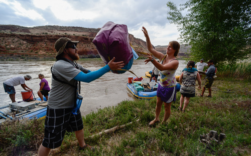 Francisco Kjolseth  |  The Salt Lake Tribune
Everyone that is able to pitches in as Brenton Winegar and Angela Mroz form part of an equipment line while unloading for the night along the banks of the Colorado River during a trip with SPLORE.