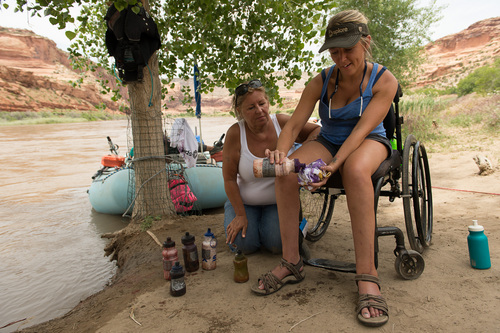 Francisco Kjolseth  |  The Salt Lake Tribune
Gabrielle Ford of Florida, a frequent guest with SPLORE, steadies herself as she works on a tie-dye shirt along the edge of the Colorado River while her mother Rhonda Hillman joins her for the first time on one of her adventures.