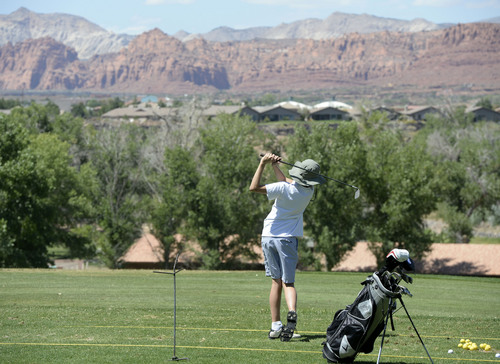 Al Hartmann  |  The Salt Lake Tribune 
Golfing in St. George during the Summer months often means playing in temperatures over 100 degrees.  It doesn't stop Jack Walton, a sophomore at Snow Canyon High School from hitting a bucket of balls at Sunbrook Golf course's driving range Friday June 29 in the late afternoon when temperature reached 100 degrees.  Note the floppy hat.