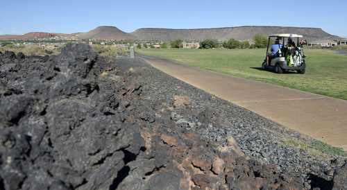 Al Hartmann  |  The Salt Lake Tribune 
Golfing in St. George during the Summer months often means playing in temperatures over 100 degrees.   Lisa and Joe Manumaleuna play at Sunbrook golf course on the part of the course with lava beds.  As if the course isn't hot enough, the black lava rocks absorb and hold in the heat.  They had most of the course to themselves though.