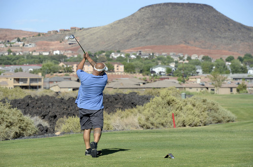 Al Hartmann  |  The Salt Lake Tribune 
Golfing in St. George during the Summer months often means playing in temperatures over 100 degrees.  Joe Manumaleuna drives at Sunbrook golf course on the part of the course with lava beds.  As if the course isn't hot enough, the black lava rocks absorb and hold in the heat. He had most of the course to himself.