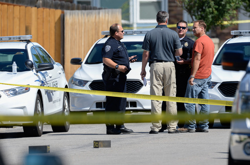 Francisco Kjolseth  |  The Salt Lake Tribune
Unified Police investigate the scene where one of their officers shot an armed man in Taylorsville on Friday morning, Aug 1, 2014. The man with the gun outside a residence at 5514 S. Ridgecrest (3400 West) was shot at least once and is reported in serious condition.